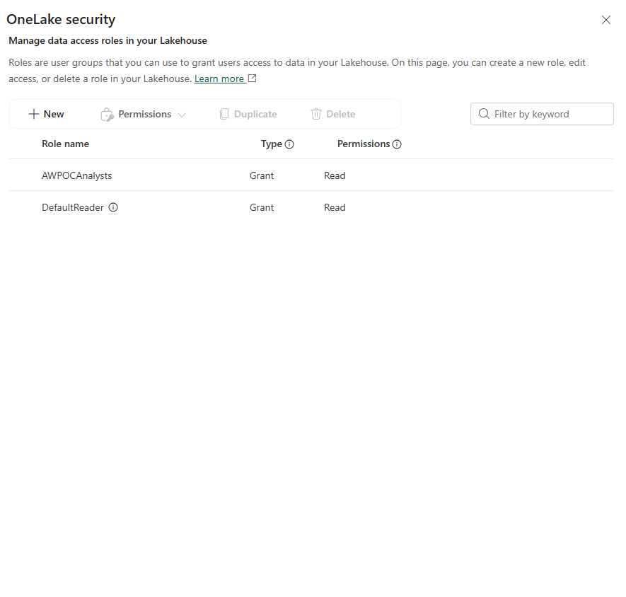 OneLake security panel — two roles: AWPOCAnalysts (Grant, Read) and DefaultReader (Grant, Read)